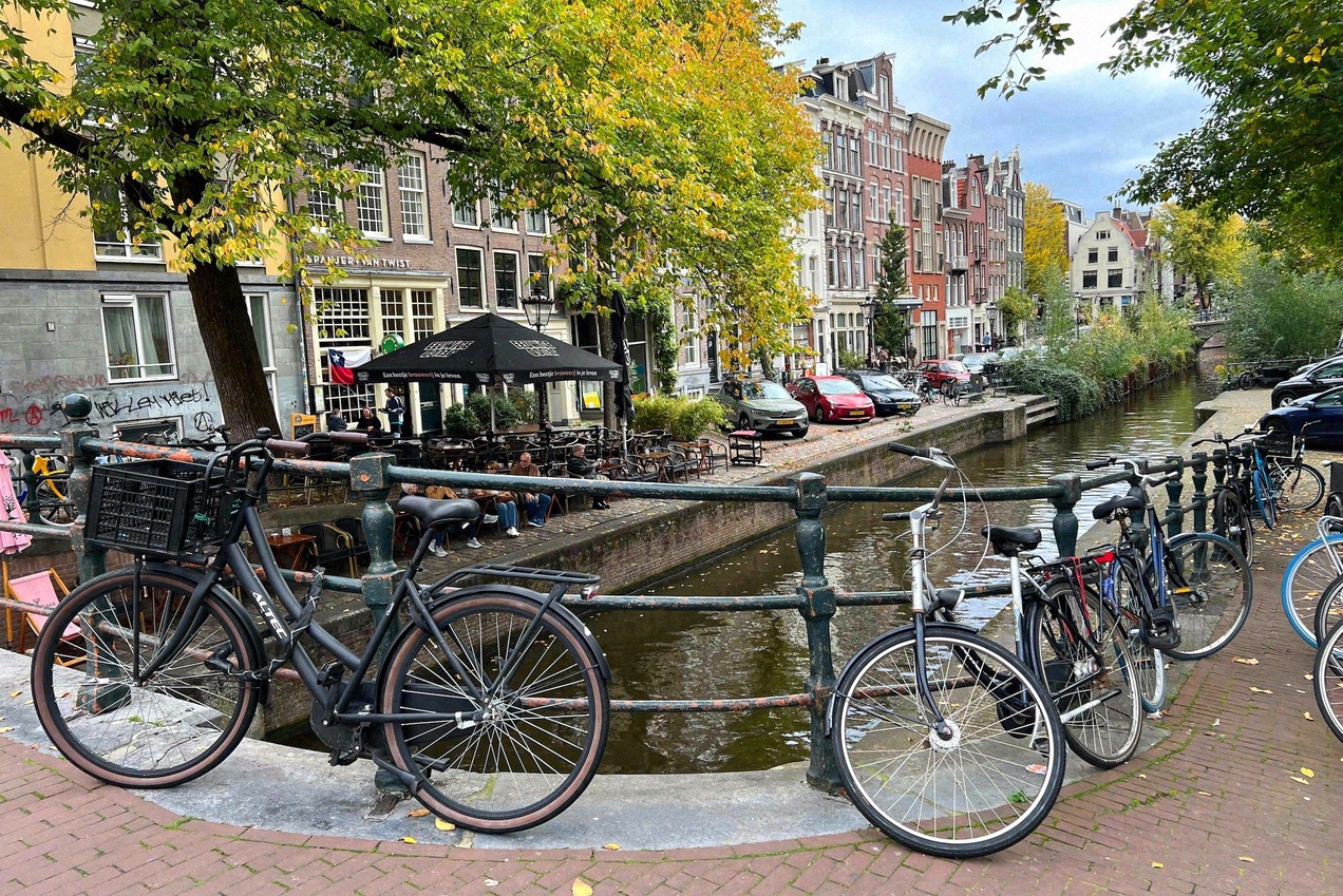 Typical Amsterdam canal with bicycles on the bridge and gabled houses