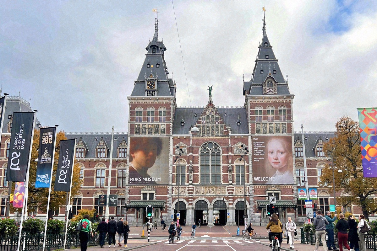 Neo-Gothic brick facade of the Rijksmuseum on Museumplein with Rembrandt banners
