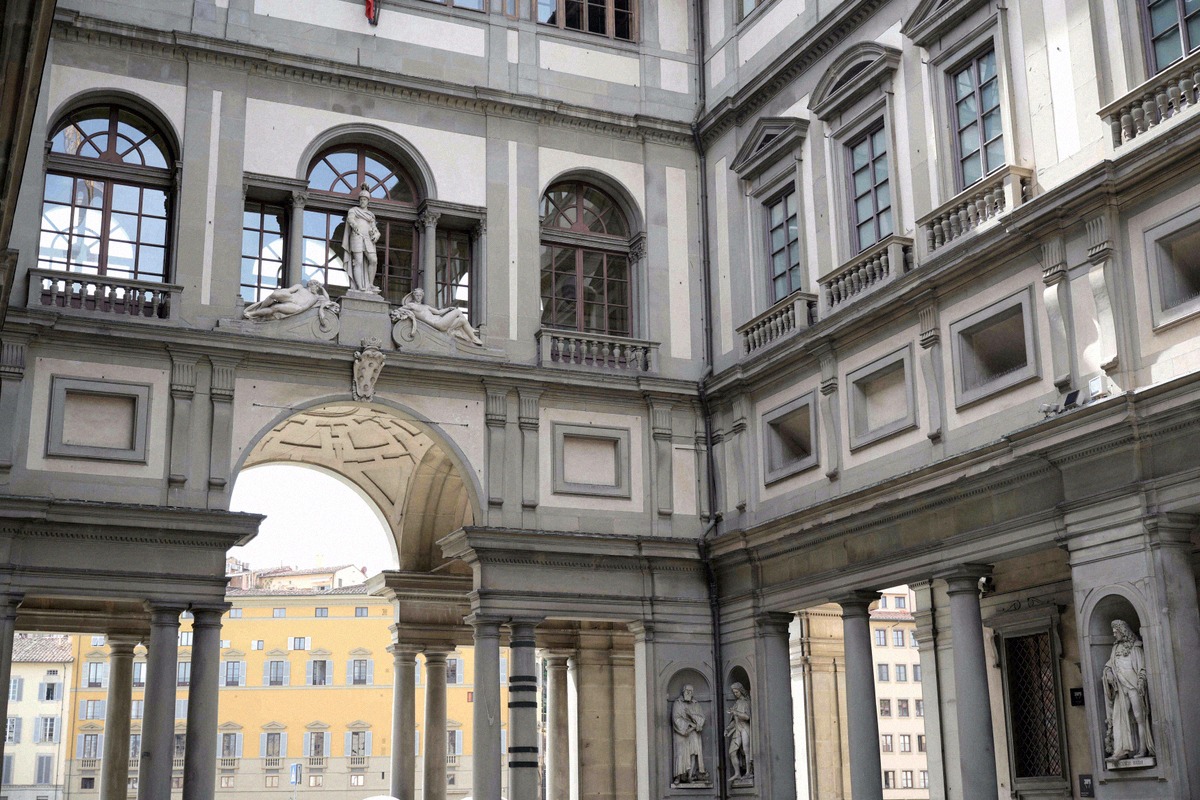 Courtyard of the Uffizi with the arched colonnades of the gallery facade
