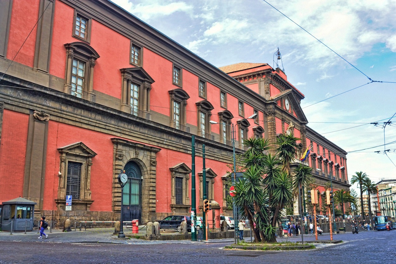 Red facade of the National Archaeological Museum of Naples on Piazza Cavour